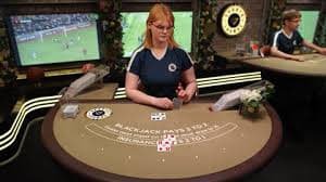 Live baccarat dealer at rp77 login studio dealing cards at green felt table